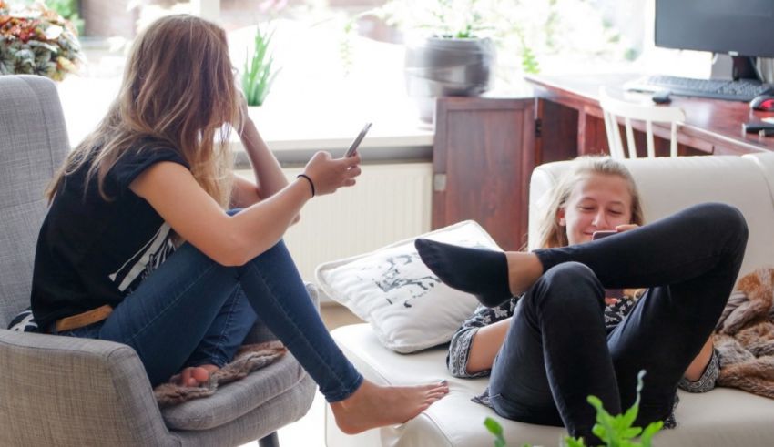 Two women sitting on a couch.