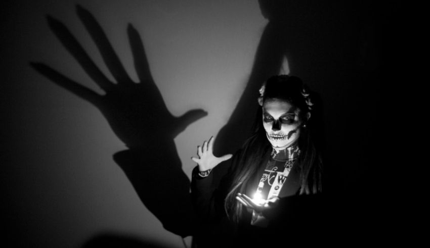 A black and white photo of a skeleton holding a candle.