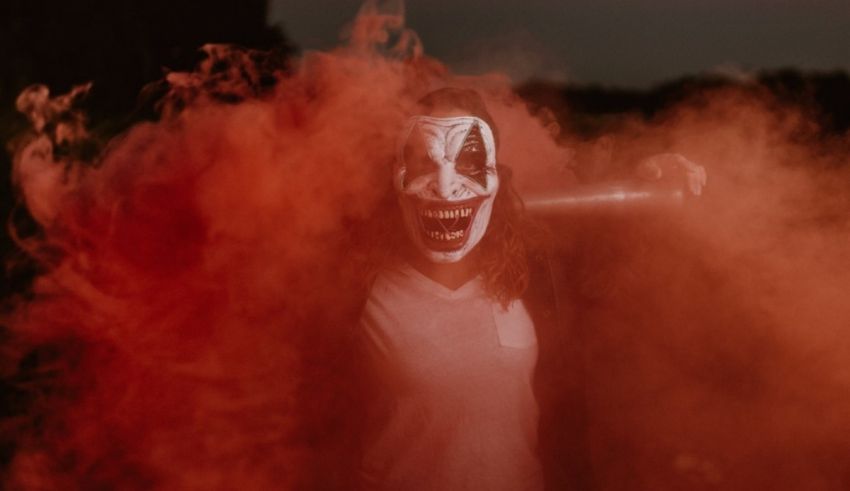 A person wearing a mask and holding a bat.