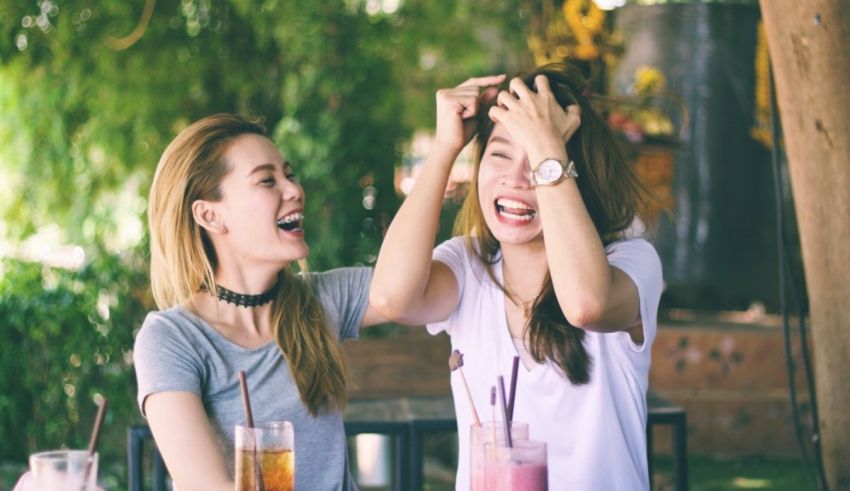 Two women laughing at each other.