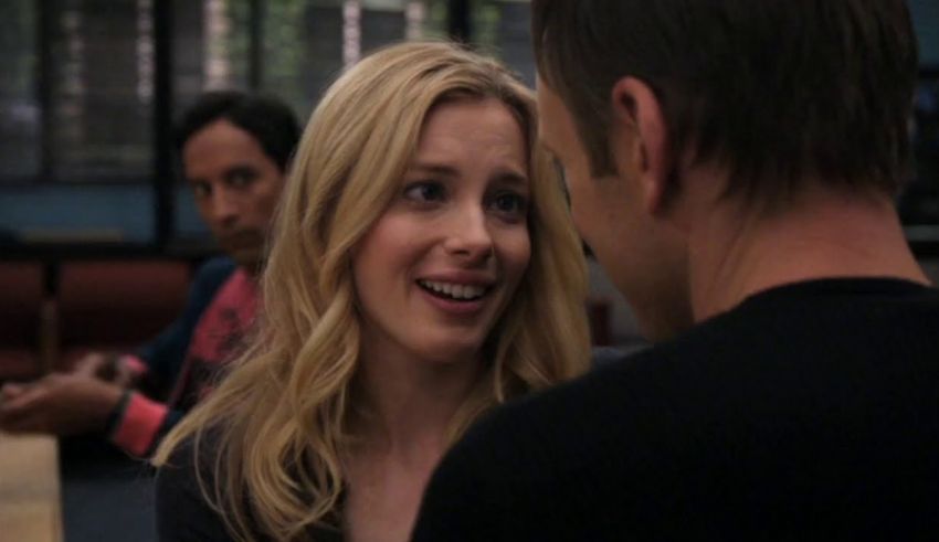 A woman is talking to a man in a room.