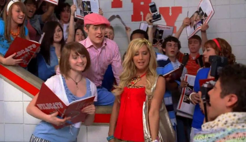 A group of people posing for a picture in a school hallway.