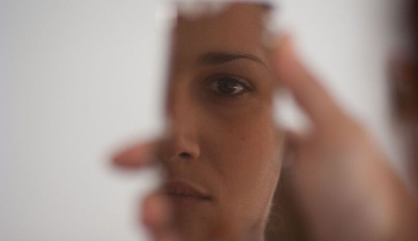 A woman holding a mirror.