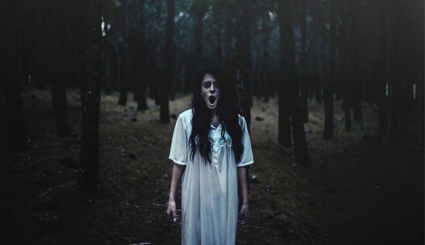 A woman in a white dress with her mouth open.