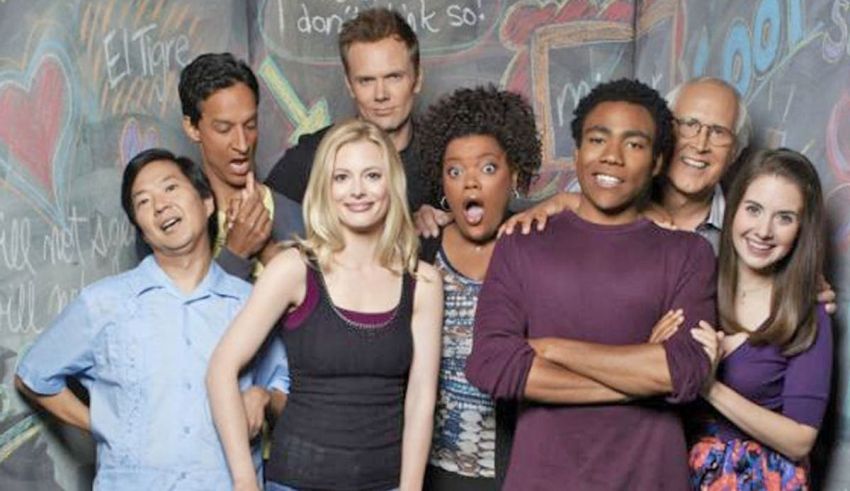 A group of people posing in front of a chalkboard.