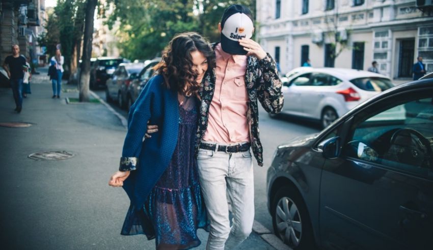 A man and woman walking on a street.