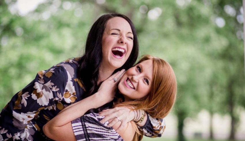 Two women hugging each other in a park.