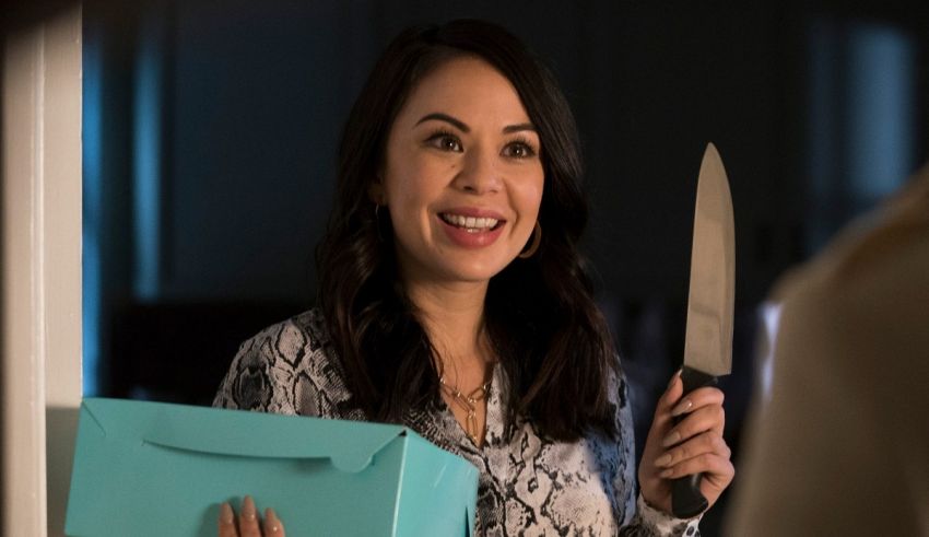A woman holding a blue box with a knife in it.