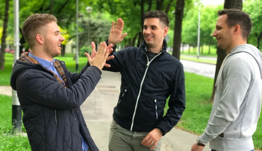 A group of men giving each other a high five.