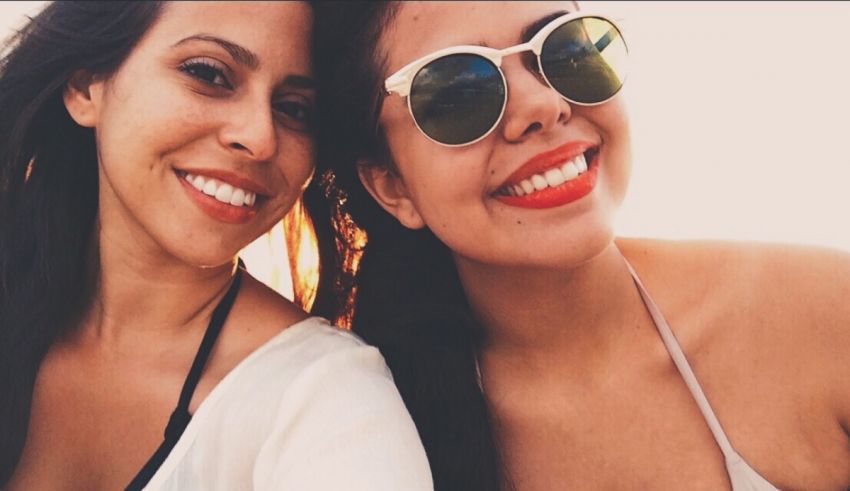 Two women in sunglasses posing for a selfie.