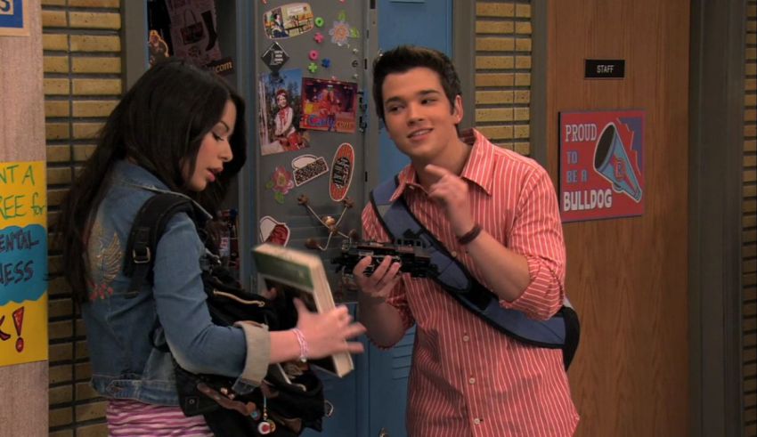 A man and a woman standing next to each other in a hallway.