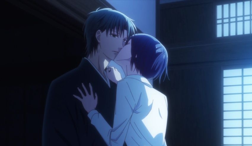 An anime couple kissing in a dark room.