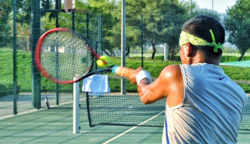 A man hitting a tennis ball with a racket.