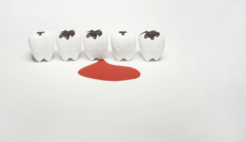 A group of small white figurines with a red splatter on them.