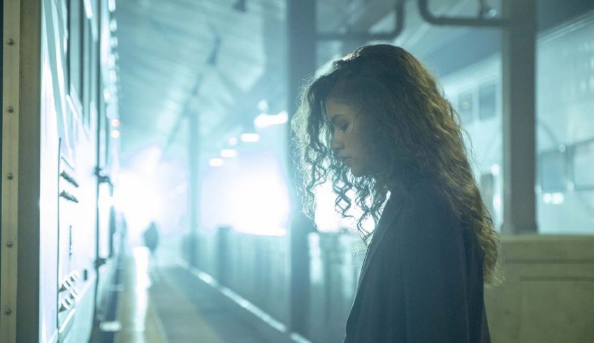 A young woman standing in a train station.