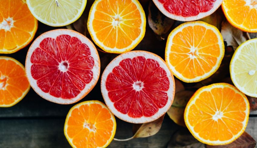 Sliced oranges and lemons on a wooden table.