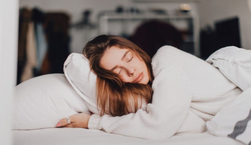 A woman sleeping in a bed with pillows.