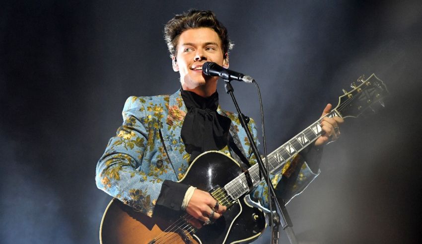 A man holding a guitar and singing into a microphone.