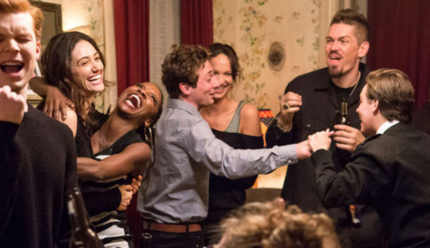 A group of people laughing together in a room.