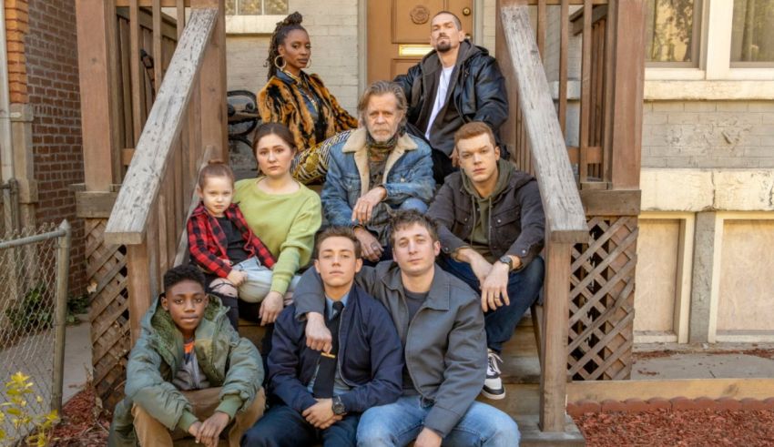 A group of people sitting on the steps of a house.