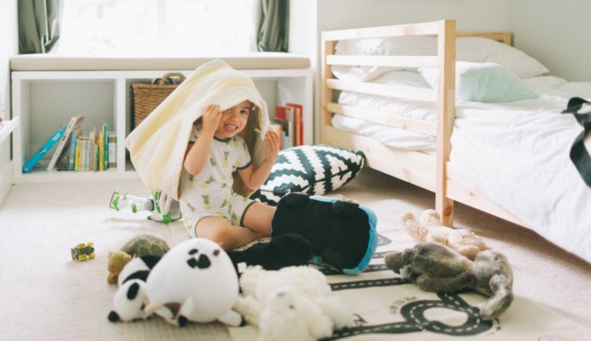 A little girl playing with stuffed animals in her bedroom.