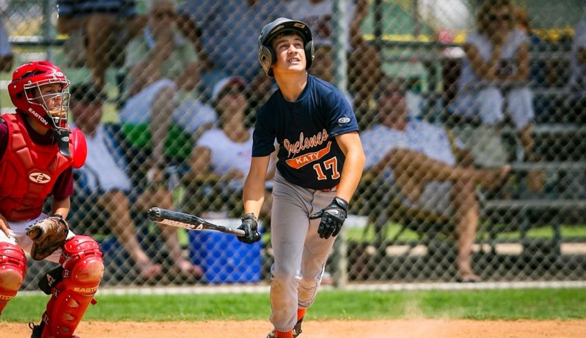 A baseball player swinging a bat in a baseball game.