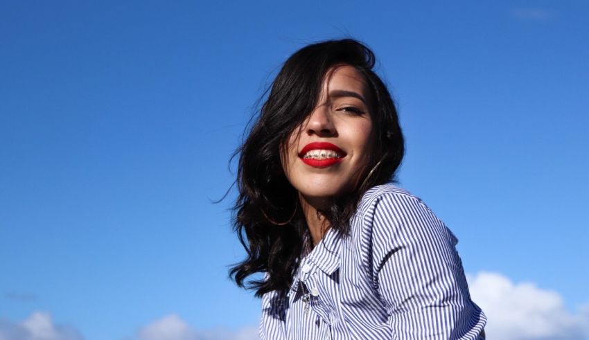 A woman wearing a striped shirt and red lipstick.