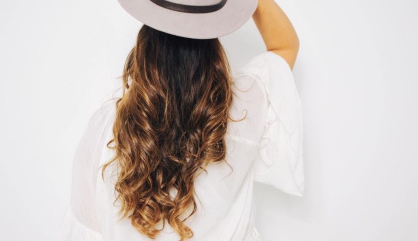 A woman with long hair wearing a hat.