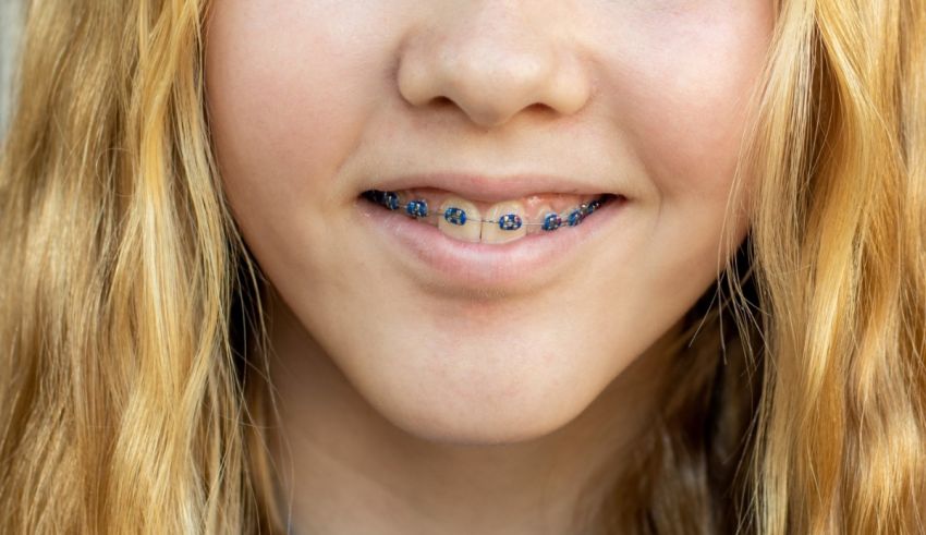 A young girl with braces on her teeth.