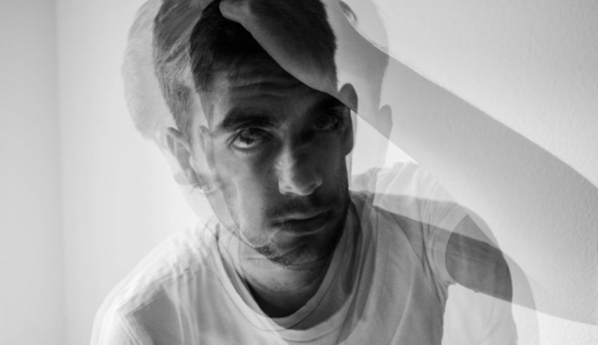 A black and white photo of a man with his head on his head.