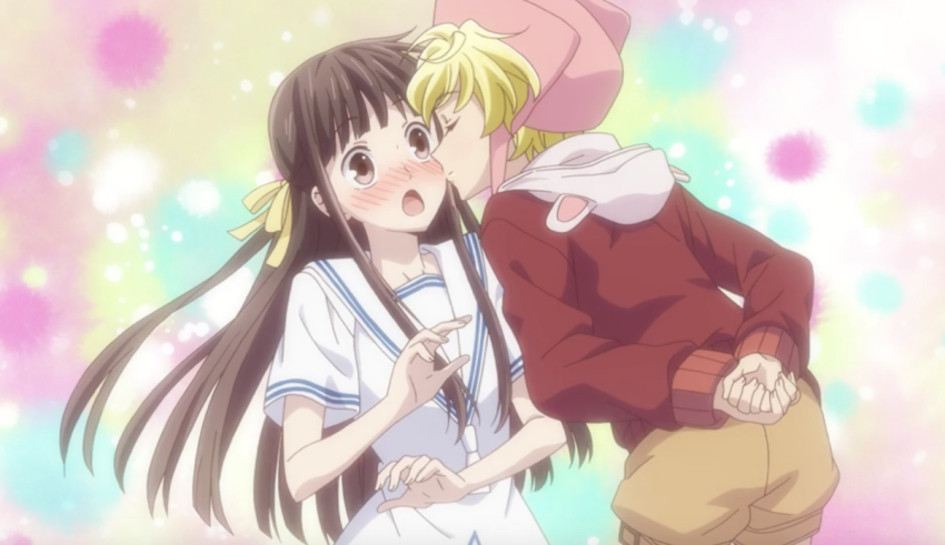 Two anime characters kissing in front of a pink background.