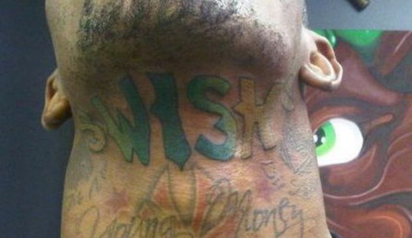 A man with a tattoo on his neck.