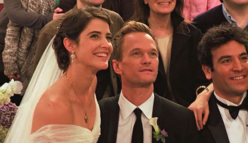 A man and woman in a wedding dress and tuxedo pose for a picture.