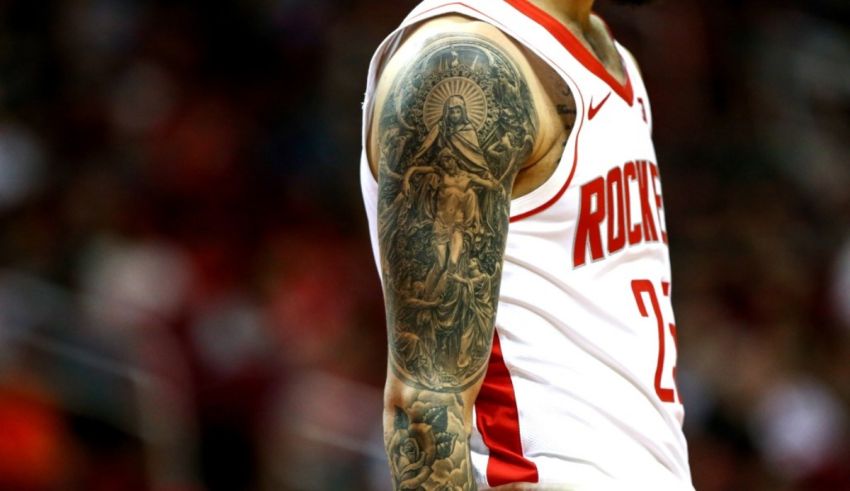A basketball player with a tattoo on his arm.