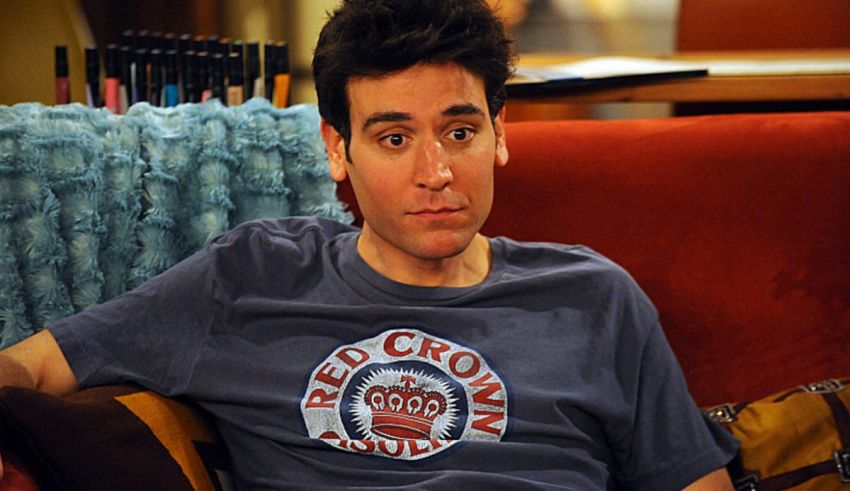 A man sitting on a couch with a crown on his head.