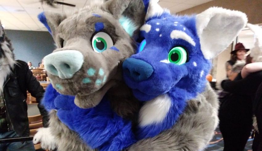 Two stuffed animals hugging each other at a convention.