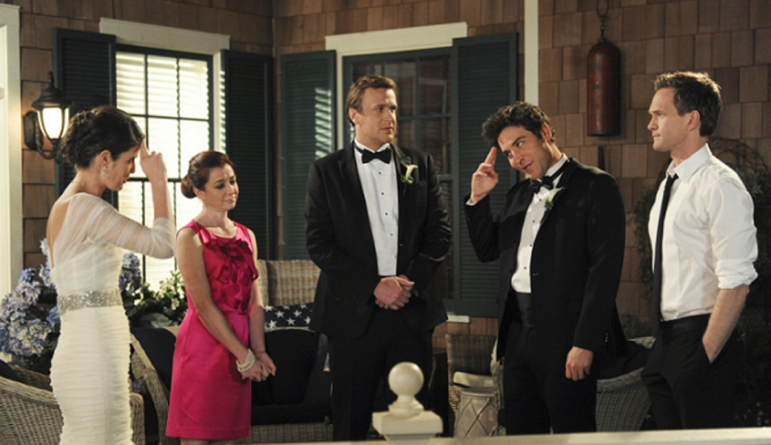 A group of people in tuxedos standing next to each other.