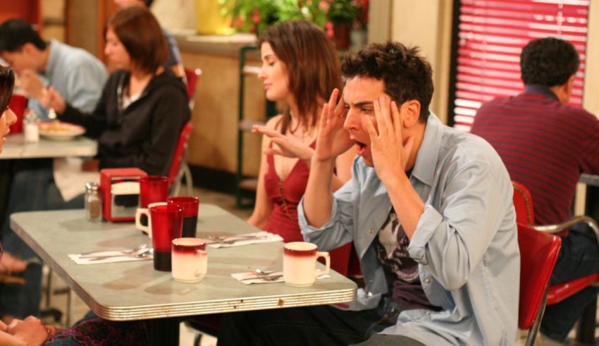 A group of people sitting at a table in a diner.