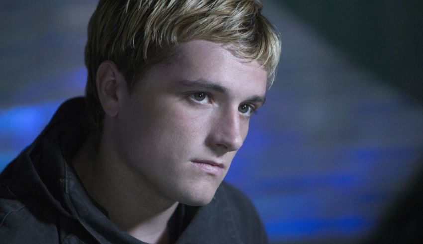 A young man in a black hoodie staring off into the distance.