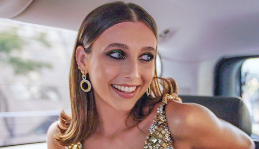 A woman in a gold dress sitting in the back of a car.