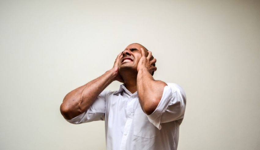 A man covering his face with his hands.