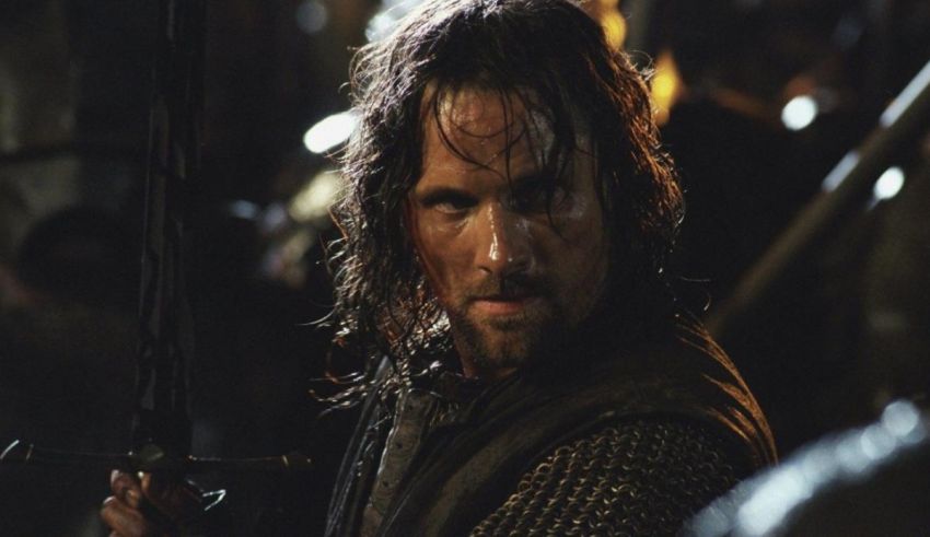 A man holding a sword in front of a crowd.