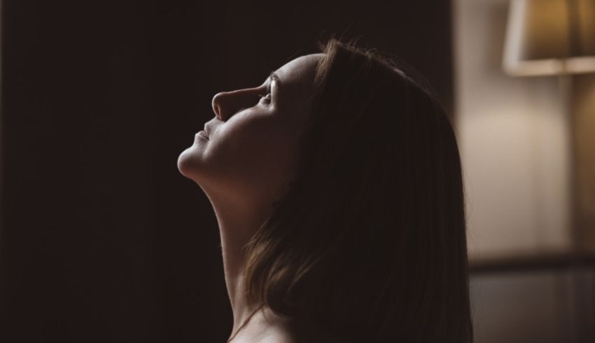 A woman looking up in the dark.