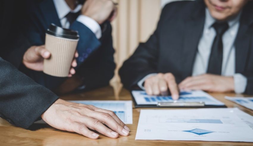 A group of business people sitting around a table.