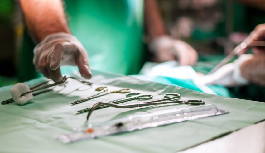 Surgeons working on a table in an operating room.