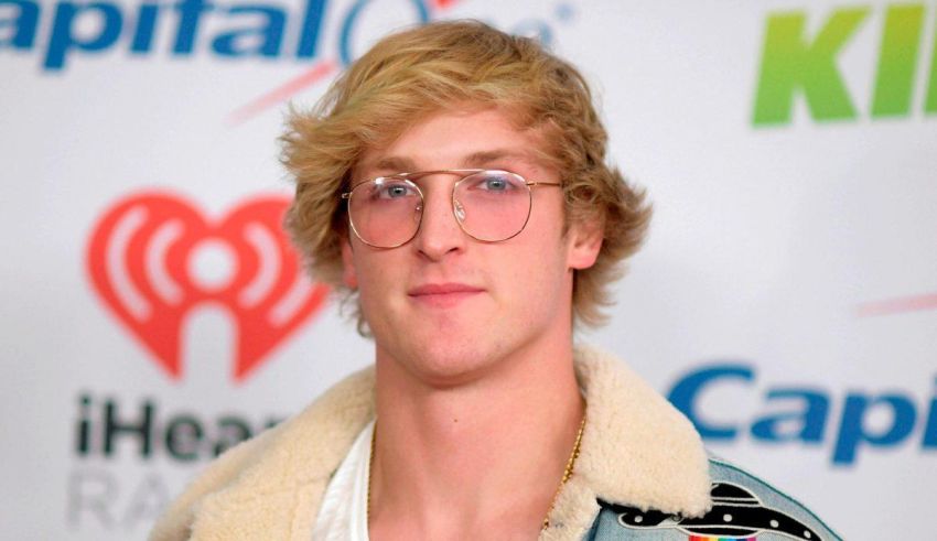 A young man wearing glasses and a jacket.