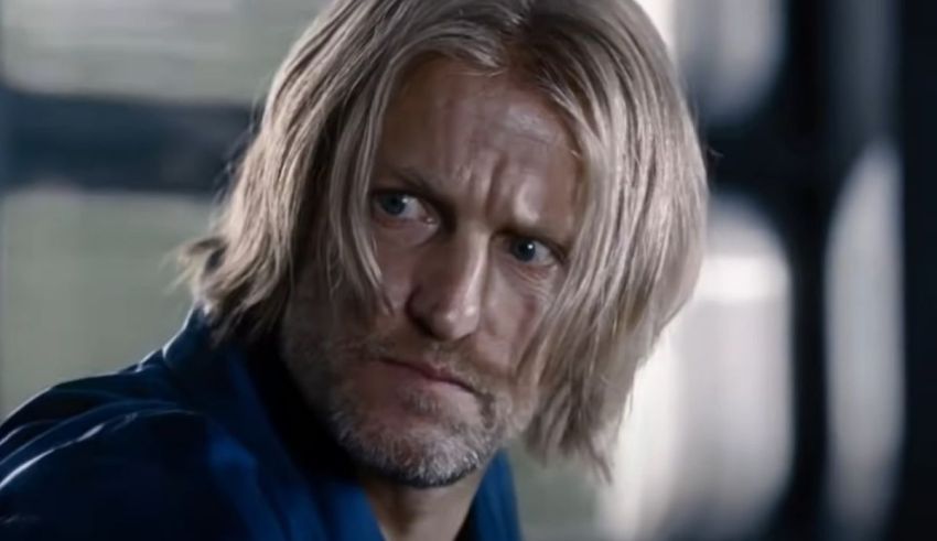 A man in a blue shirt with blonde hair.