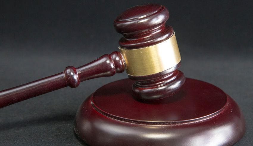 A judge's gavel on a black background.