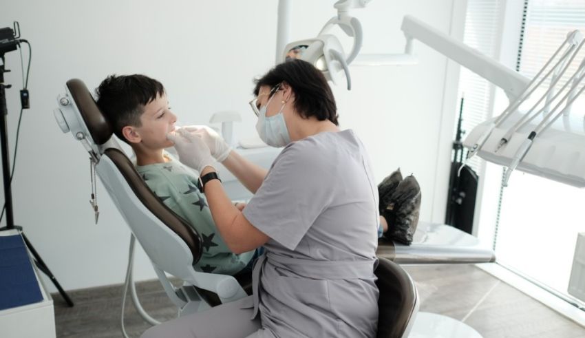 A woman is sitting in a dentist's chair.