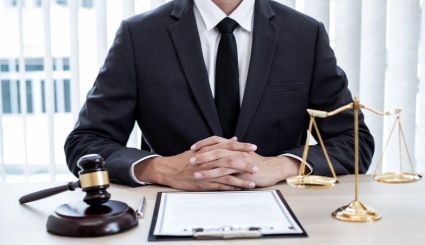 A lawyer sitting at a desk with a gavel.